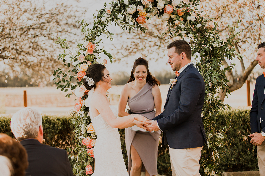 spring wedding in front of cherry blossom trees