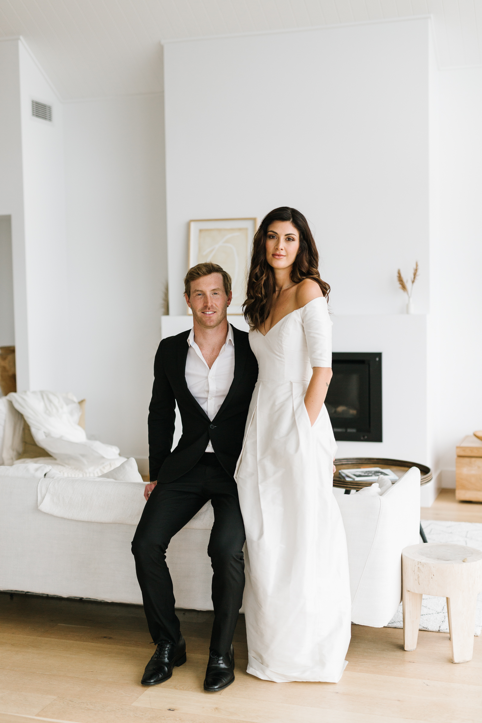 portrait of bride and groom in a white room