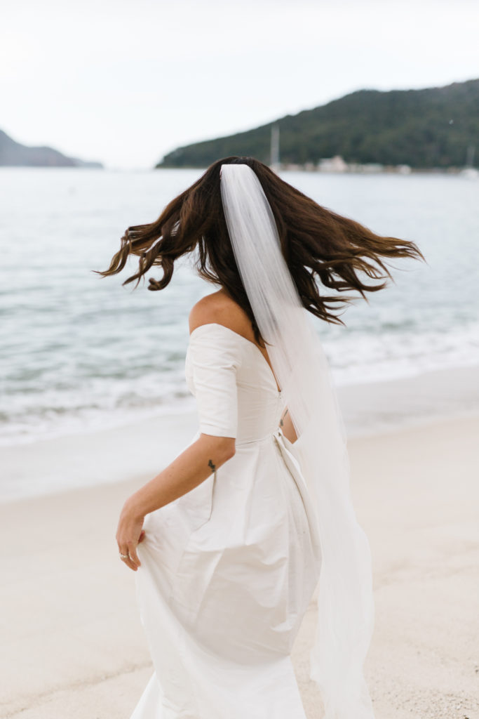 Bride spinning around for her Shoal Bay Beach Elopement 