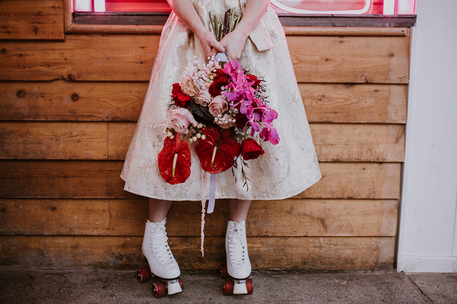 close-up shot of bride's bouquet and roller skates