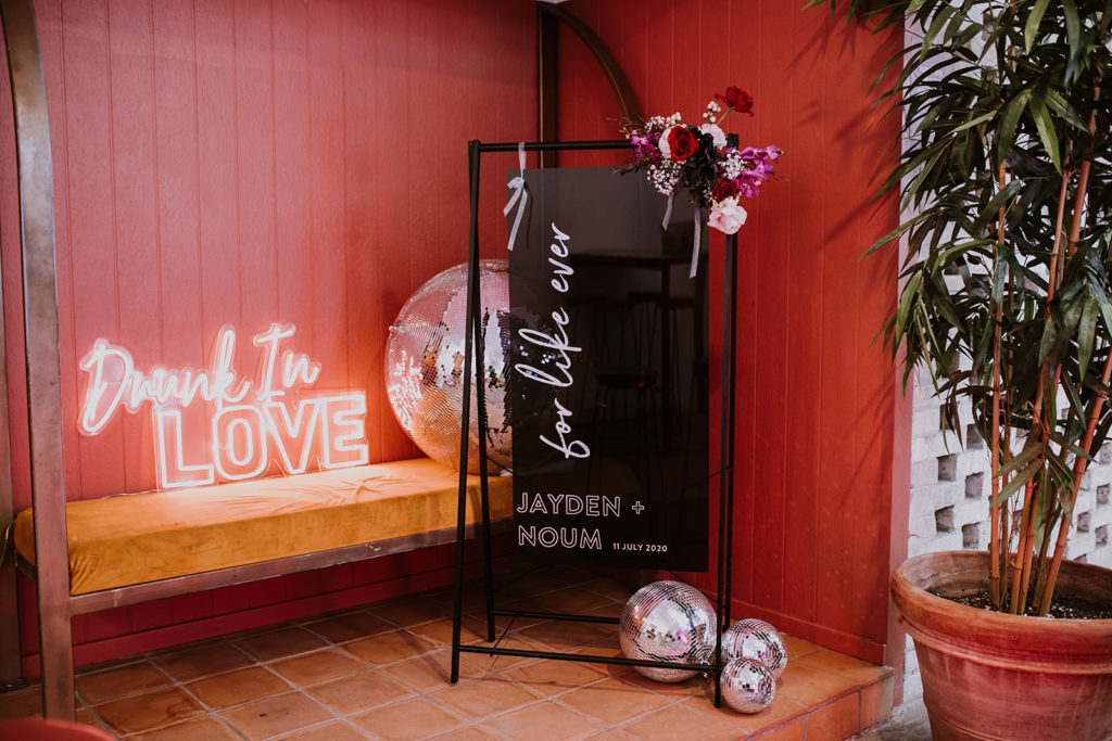 Welcome signage surrounded by disco balls for a disco inspired wedding