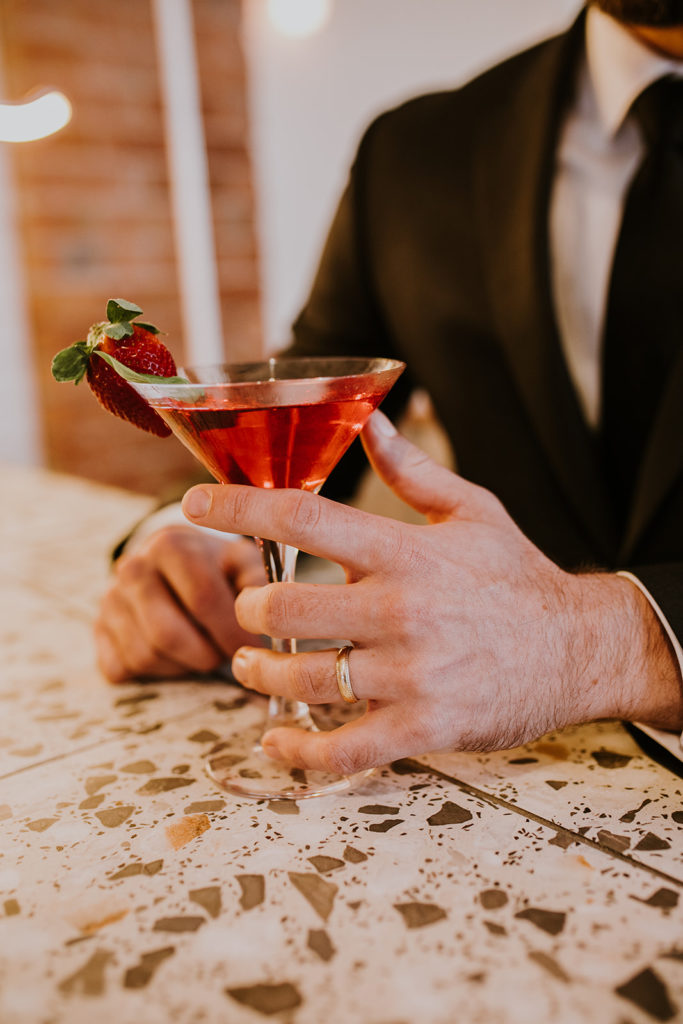 Drinking cocktails at disco inspired wedding shoot