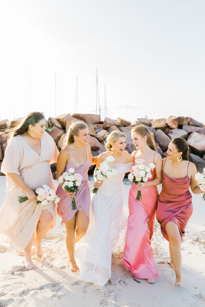 Bride walking and smiling with her bridesmaids at The Anchorage wedding