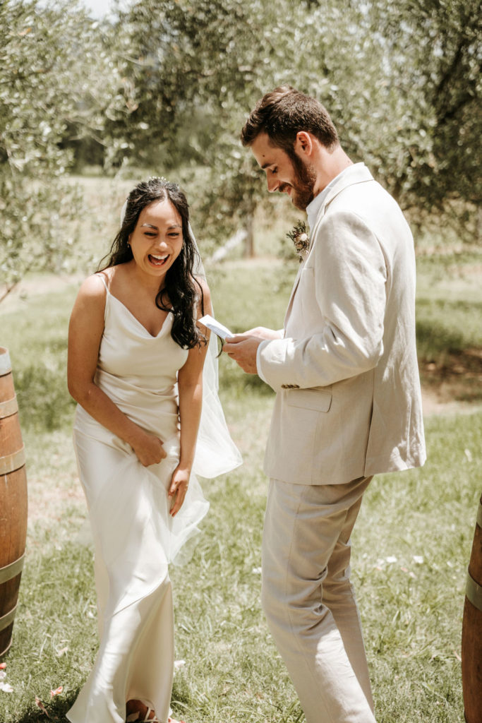 Couple read their vows between two barrells at Whispering Brook Elopement
