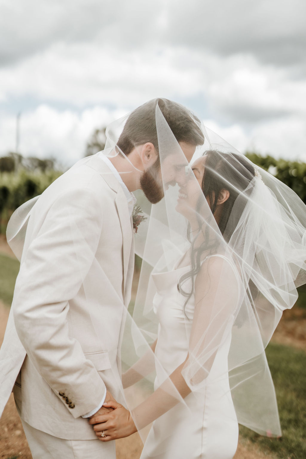 adorable bride and groom touching noses happily