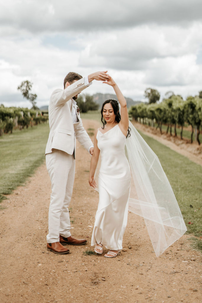 Couple dance through the vines during Whispering Brook Elopement