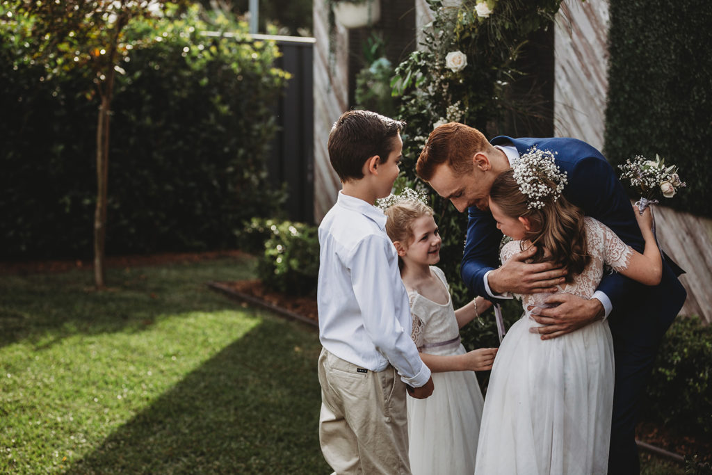 what getting married feels like: Groom greets flower girls and page boy tenatively