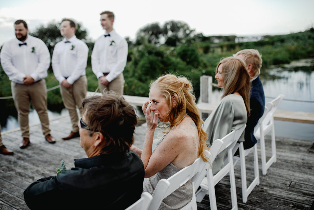 Guest gets emotional during the wedding ceremony at Caves Coastal Bar & Bungalows
