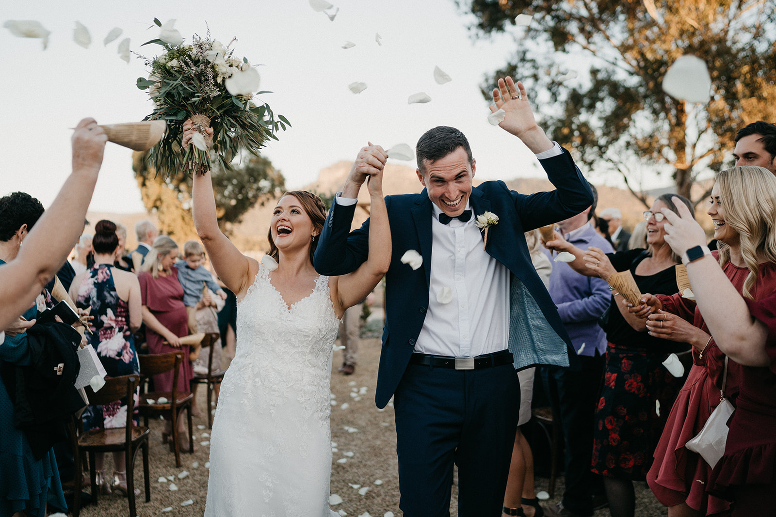 wedding guests showering eco-confetti while bride and groom walked down the aisle