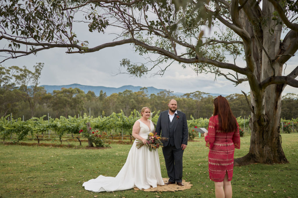 bride and groom having their ceremony with celebrant Julie Muir at Spicers Vineyard Estate