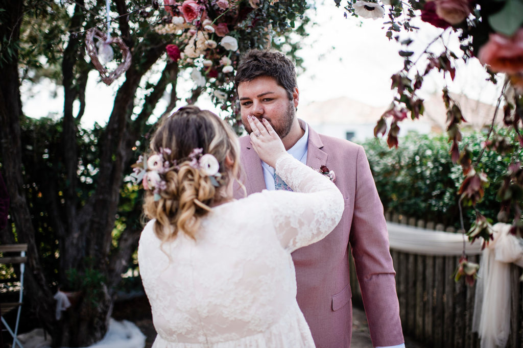 Bride wips lipsitck from her husbands mouth after kissing him at their New Lambton wedding.