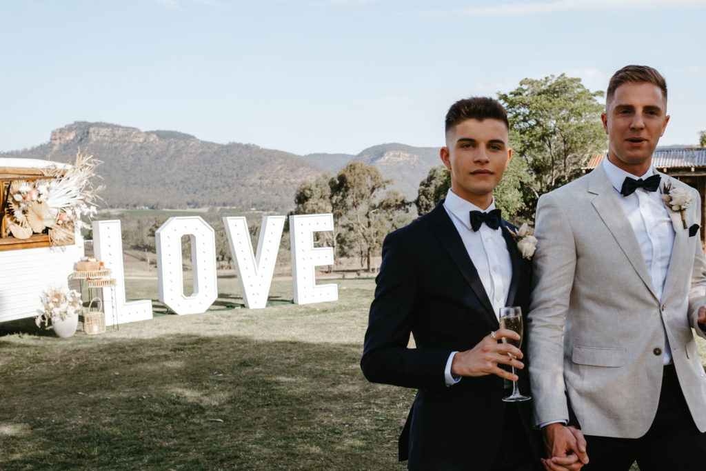 Adams Peak wedding inspiration, grooms standing in front of Love sign