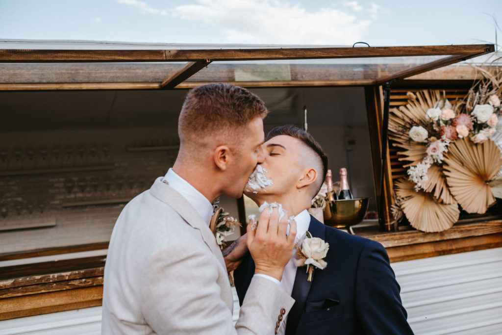 Grooms eating cake and kissing at the same time at Adams Peak wedding inspiration