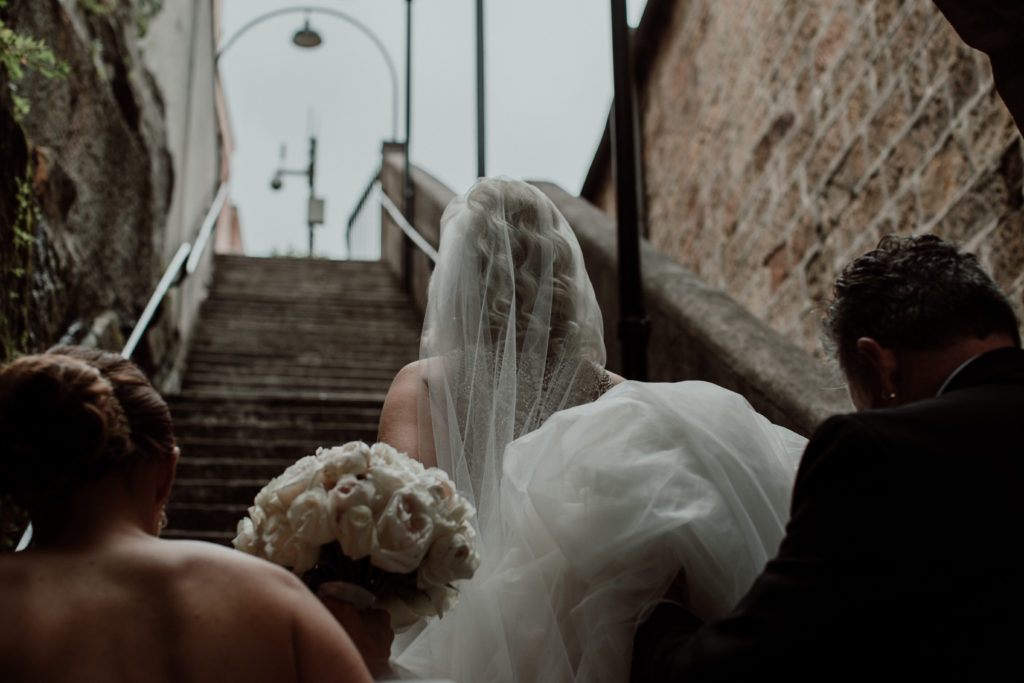 Bride climbing the stairs at Curzon Hall. before her wedding