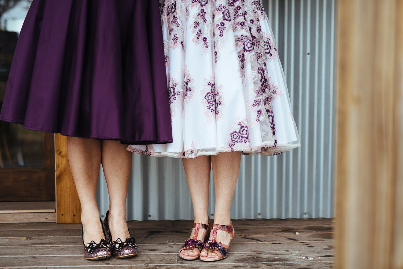 Purple knee-length skirt and white knee-length skirt with floral embroidery