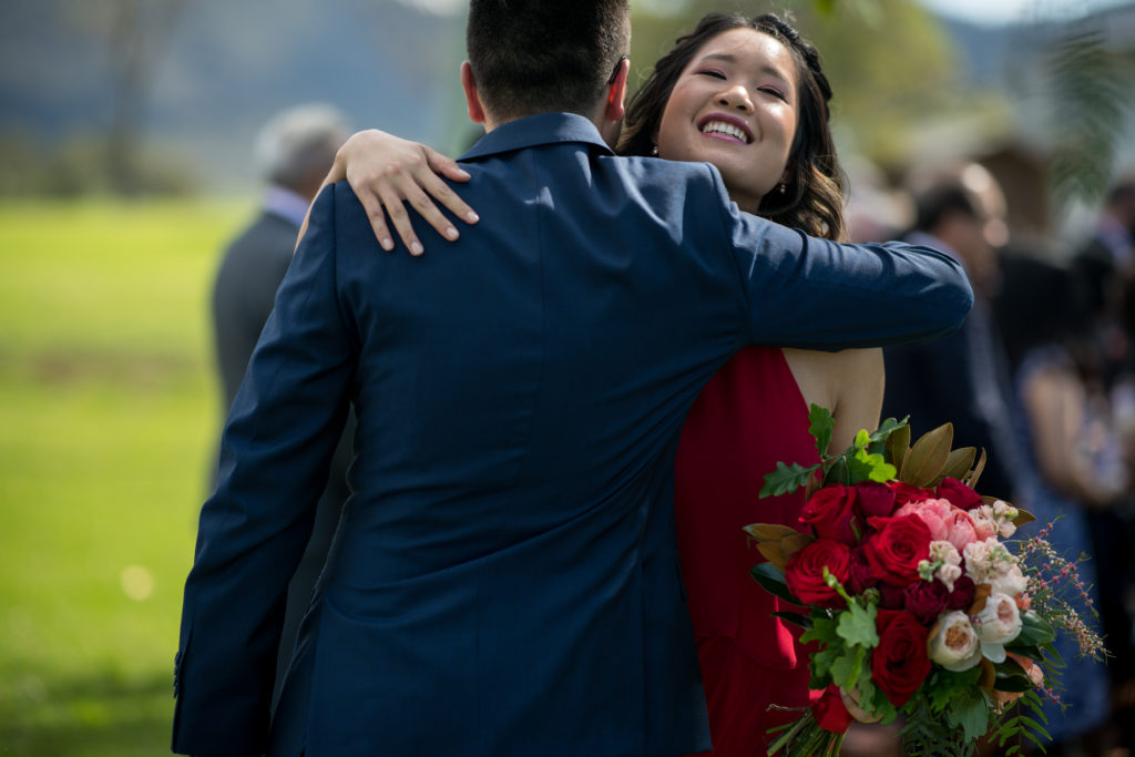 groom hugging bridesmaid at Ben Ean Winery wedding