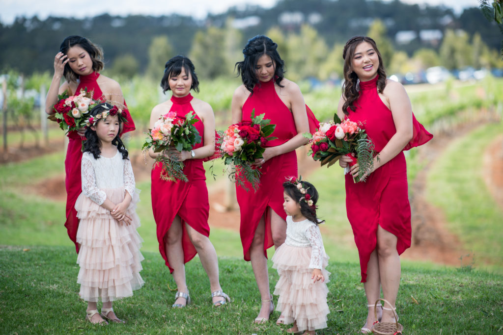 Hunter Valley Wedding Venue Ben Ean flower girsl standing in front of four bridesmaids and their bouquets