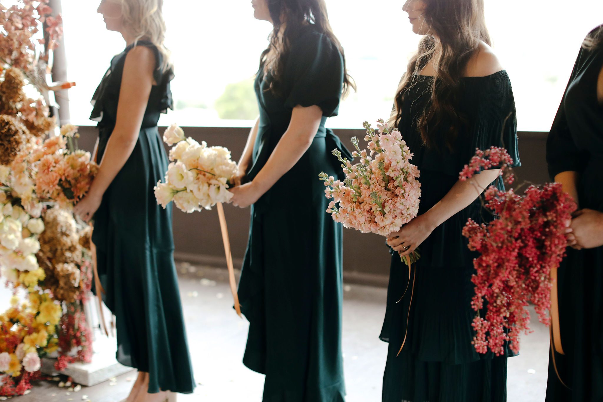 Beautiful bridesamids holding individual bouquets at Adam's Peak.