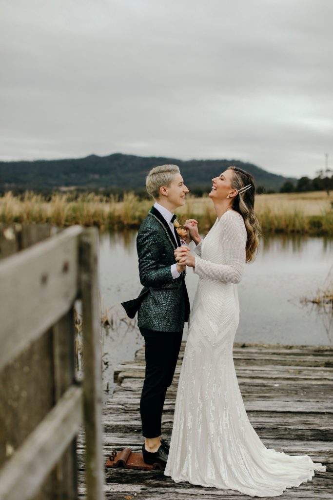 Hunter Valley Wedding Venue Adams Peak bride and groom holding hands on a wooden bridge