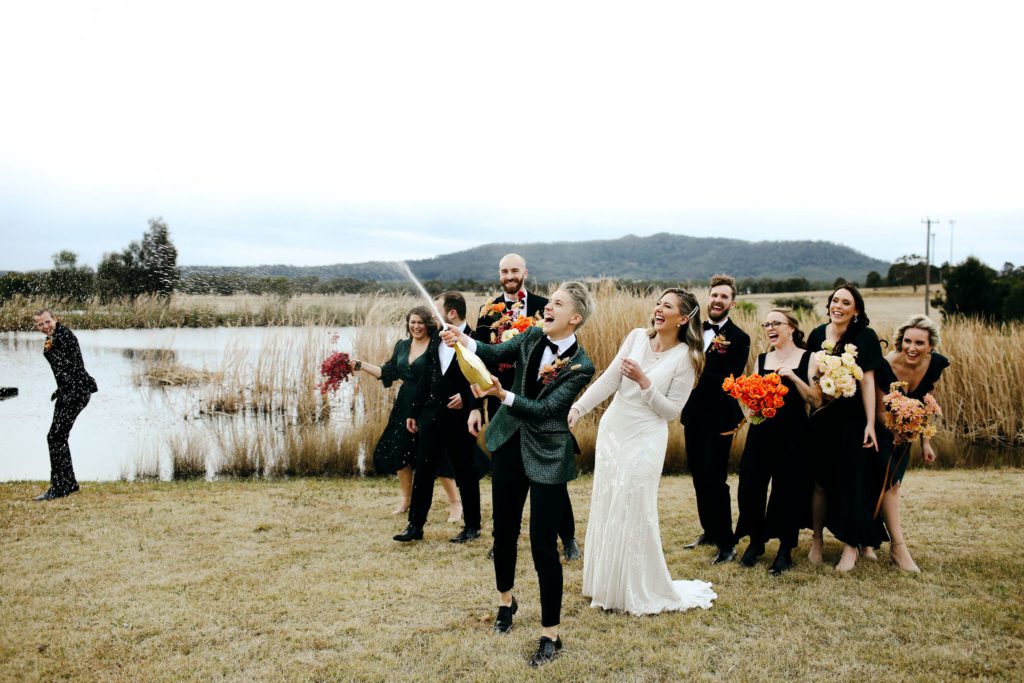 Hunter Valley Wedding Venue Adams Peak couple popping a wine bottle open