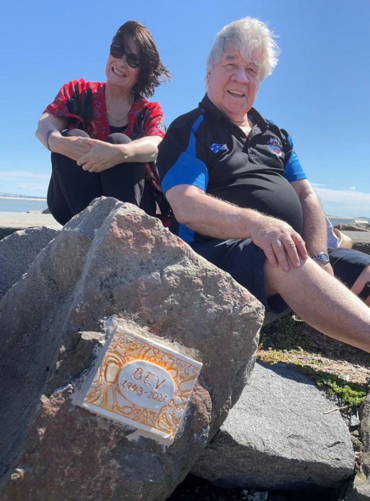 Bev Moloney's husband and daughter memorialising her with a plaque at Stockton breakwall memorial