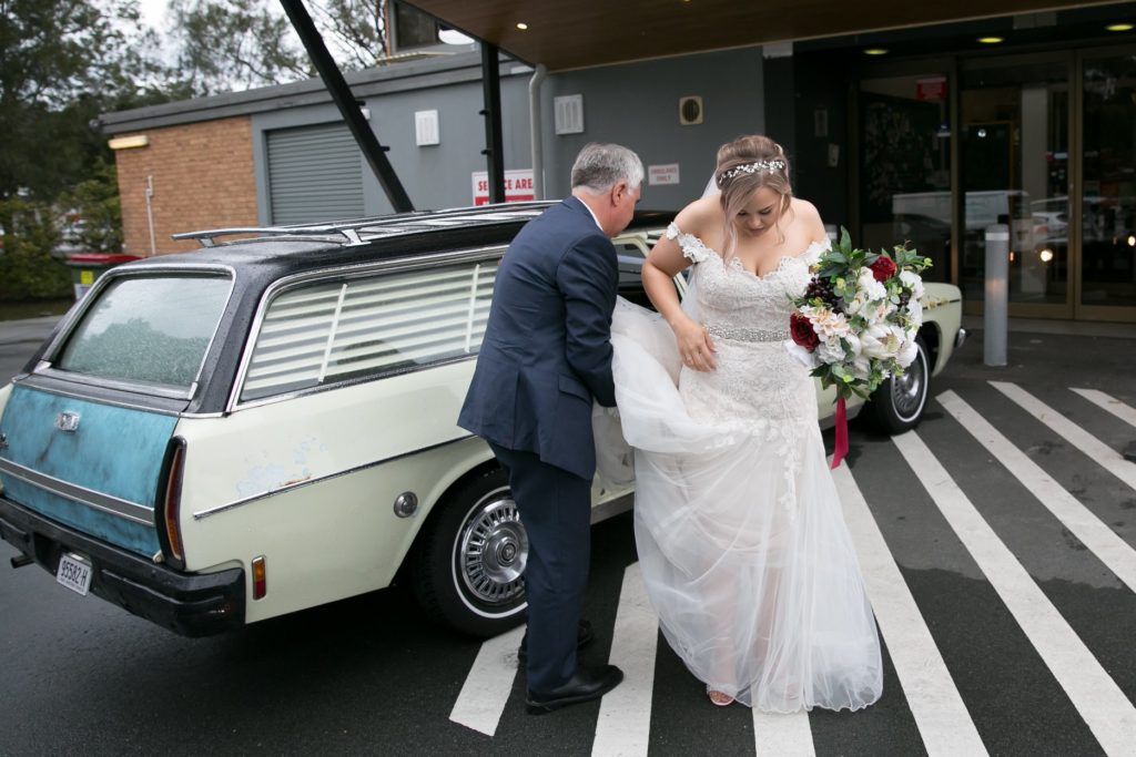 Bride crossing the street with her father