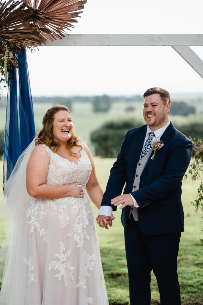 Wallalong House wedding couple laughing while holding hands