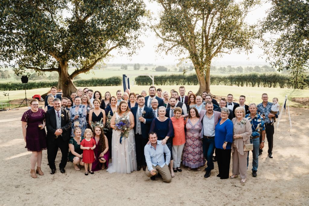 Group photo of couple and wedding guests at Wallalong House