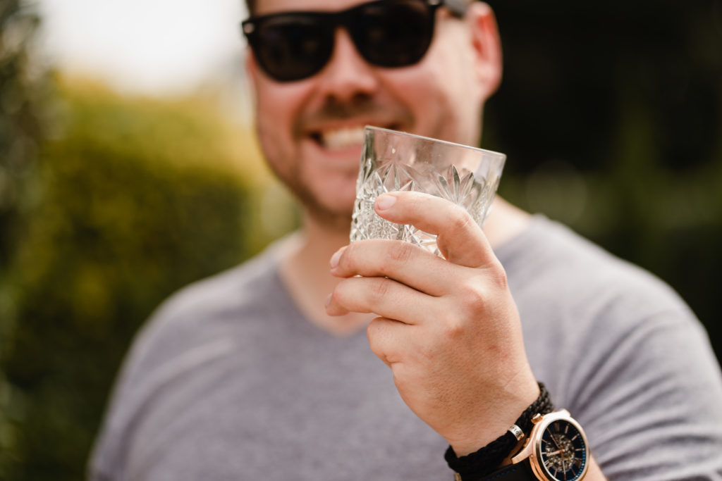 Groom holding a whiskey glass pre ceremony at Wallalong House