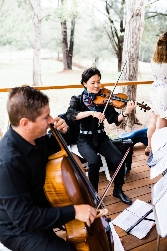 Wedding musicians playing string instruments at a Stonehurst Cedar Creek wedding