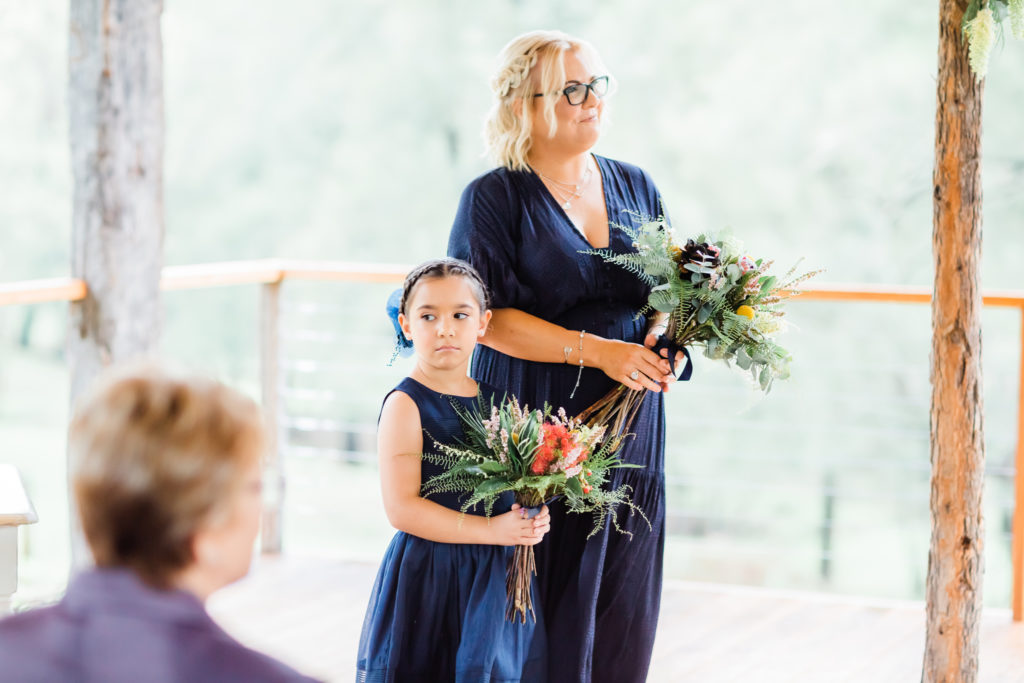 Flower girl beside the maid of honor at a Stonehurst Cedar Creek wedding