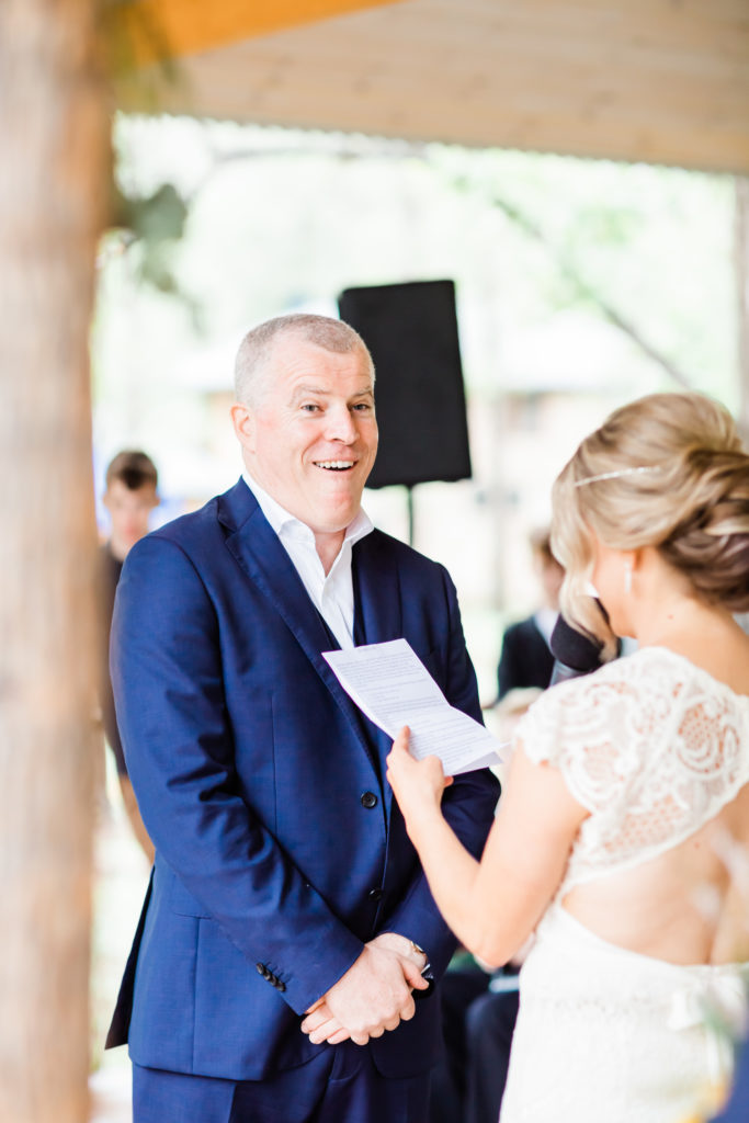 Shocked look on groom's face during vows at Stonehurst Cedar Creek Wedding
