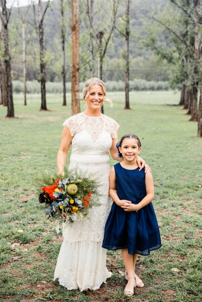 Bride and flower girl posing side by side after her Stonehurst Cedar Creek wedding