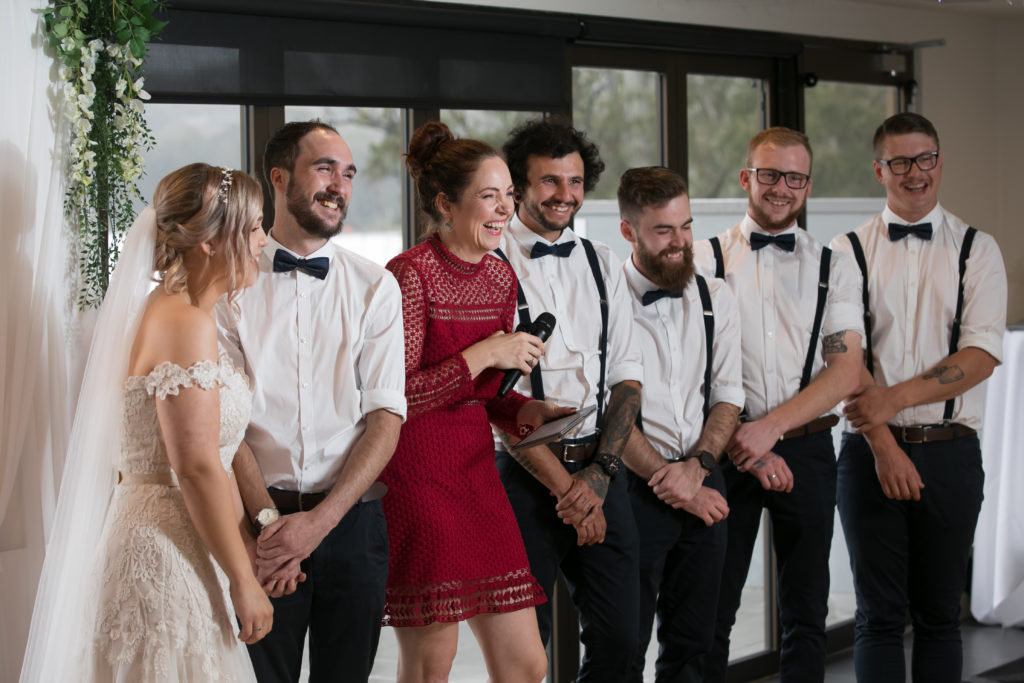 Newlyweds beside Celebrant Julie Muir and groomsmen at Valentine Bowling Club