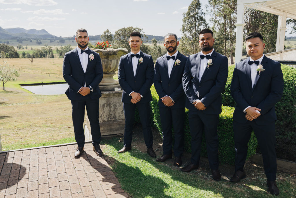 Four groomsmen standing next to groom at Voco Kirkton Park wedding
