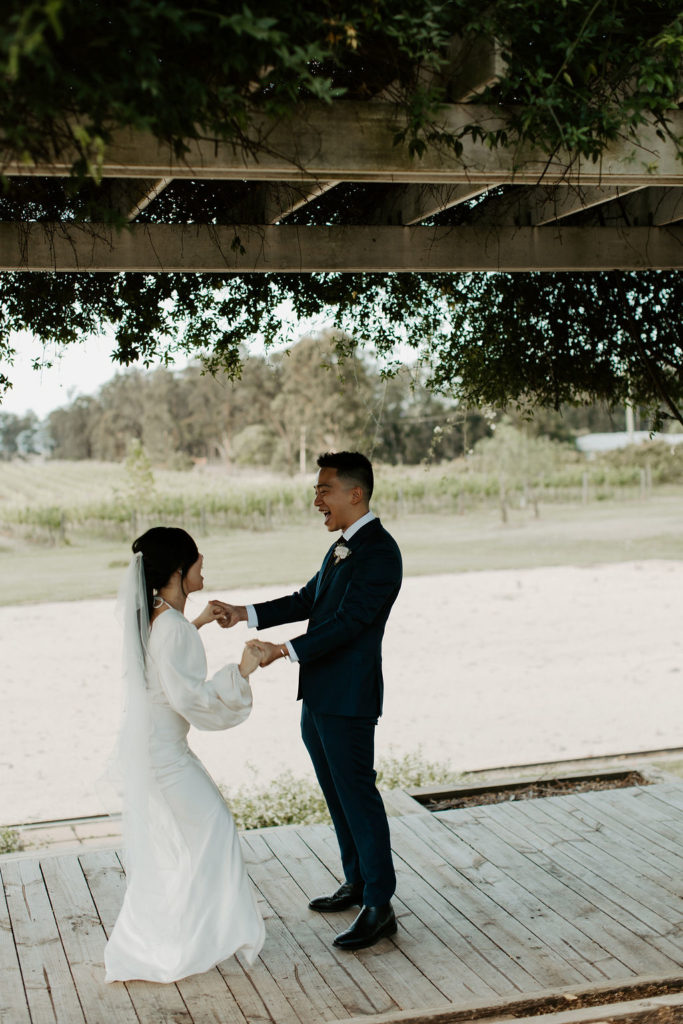 bride and groom holding hands at Vinden Wines