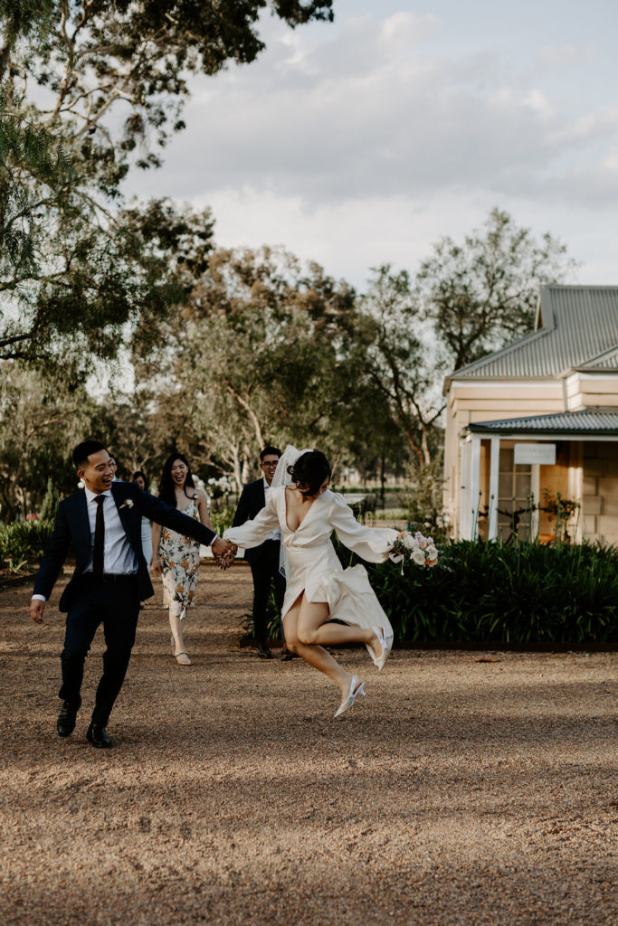 bride and groom jump shot at wedding at Vinden Wines 