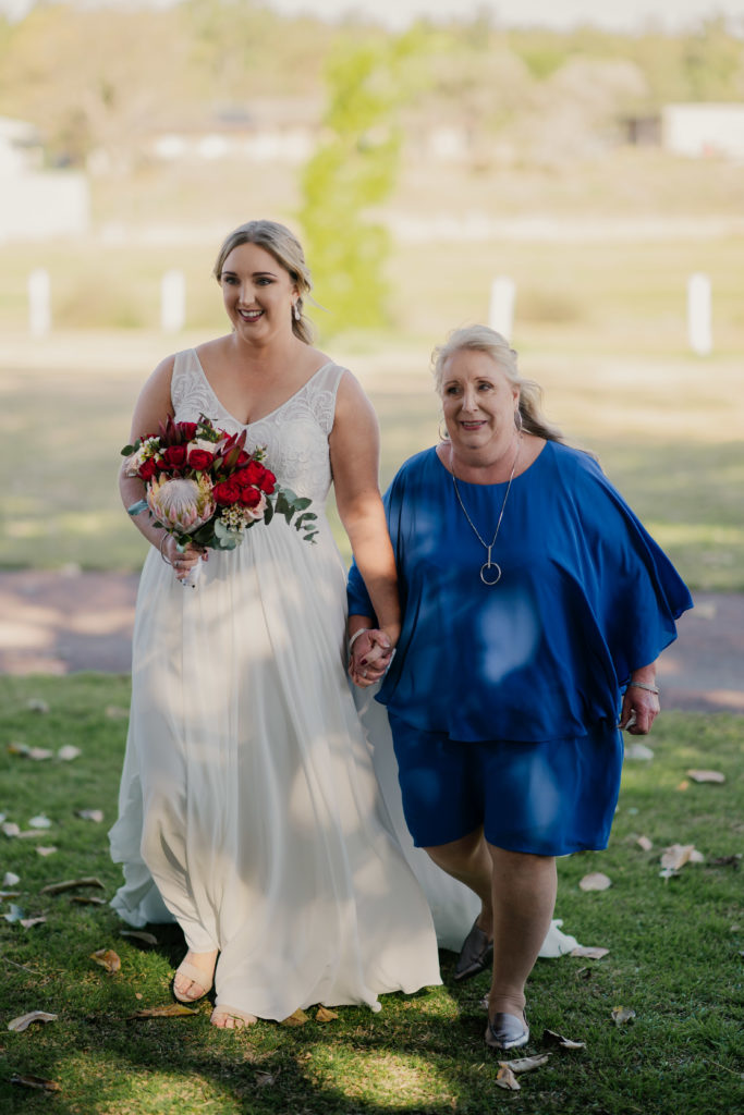 Bride walks down the aisle with her mum at Stanley Park