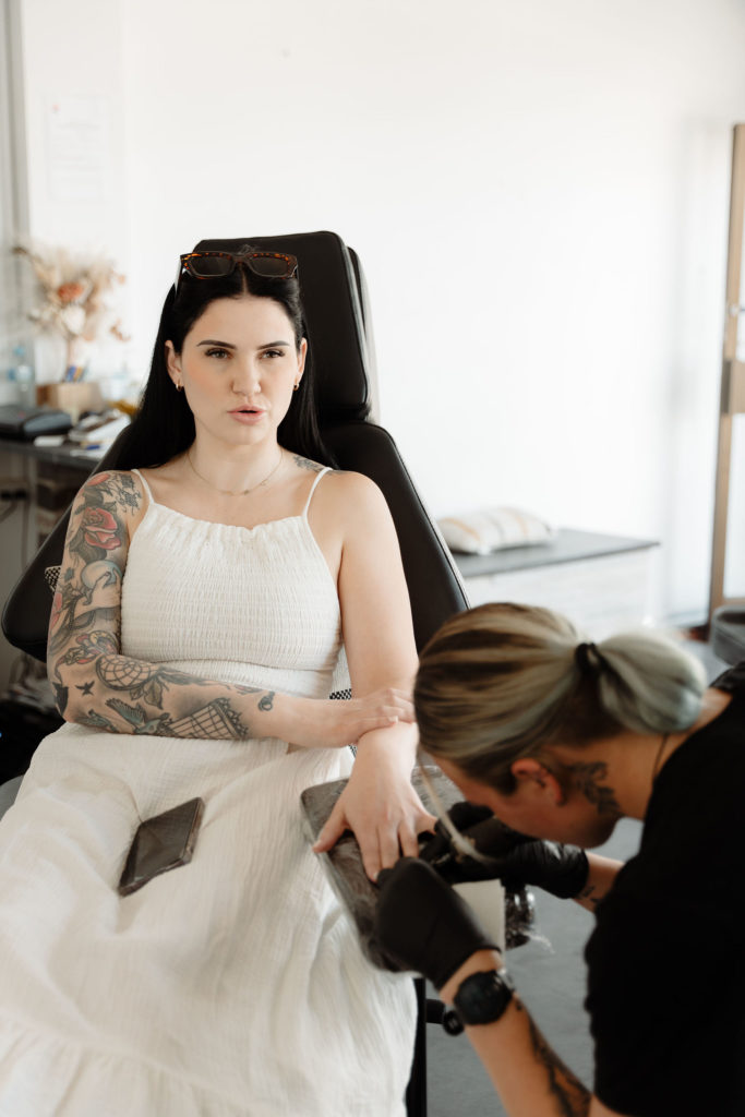 Bride getting tattooed on her wedding day