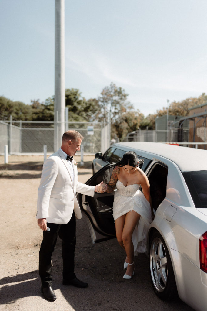 Bride's father helping bride out of the car at Hickson St Lookout wedding