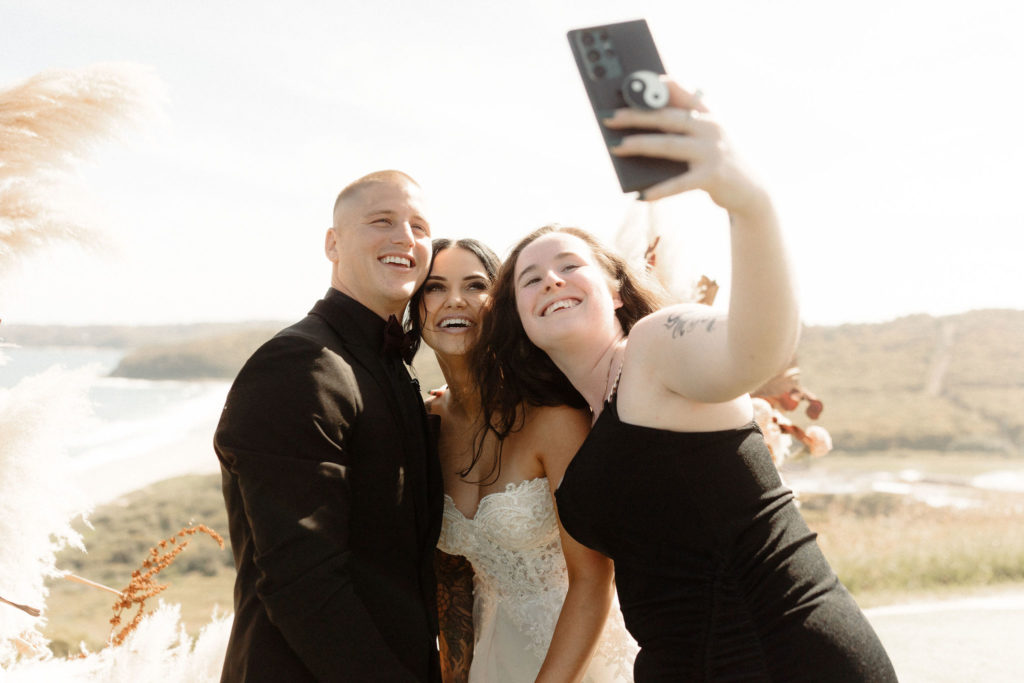 Bride and groom taking a selfie with wedding guest at Hickson St Lookout wedding