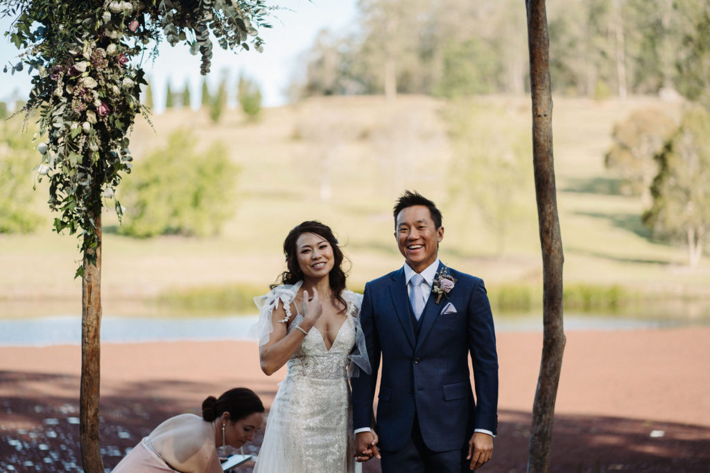 Couple laughing mid ceremony at The Woodhouse Wollombi