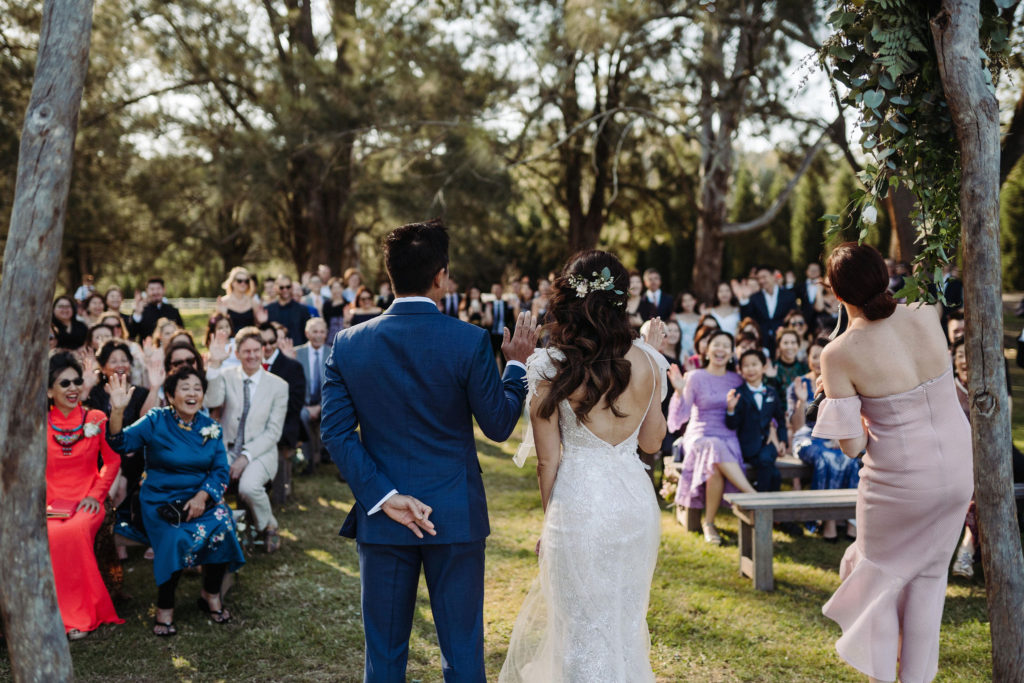 Photo of bride and groom from the back at The Woodhouse Wollombi wedding