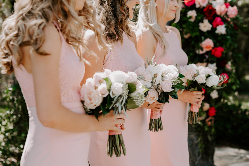 Close up shot of three bridesmaids holding their bouquets at Circa 1876 wedding