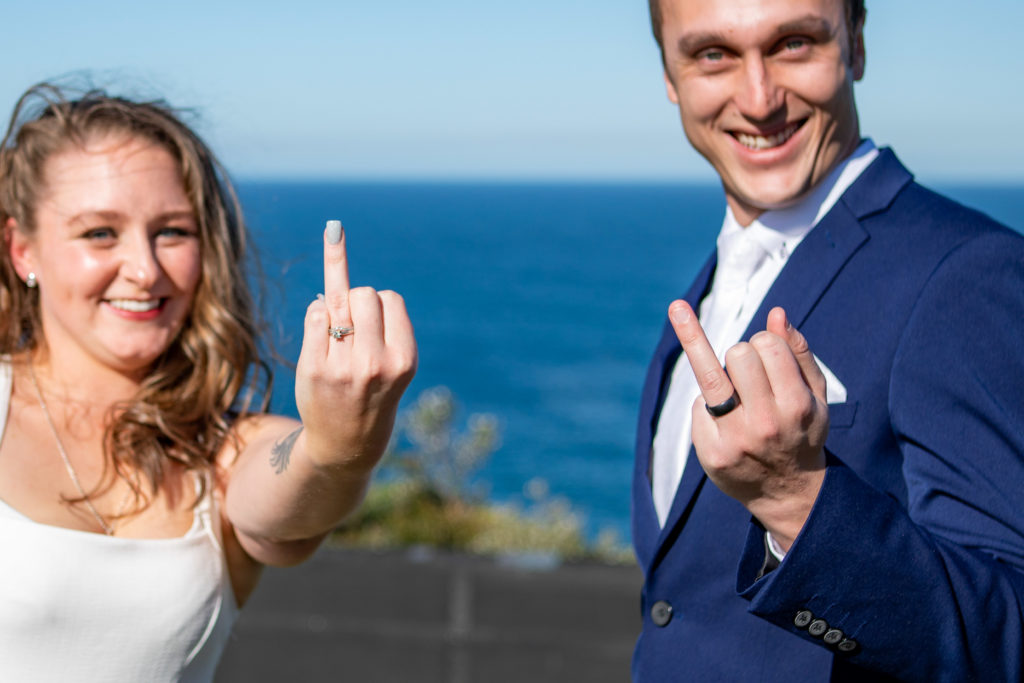 Newlyweds holding up their ring fingers to show their wedding rings at their Shepherds Hill wedding