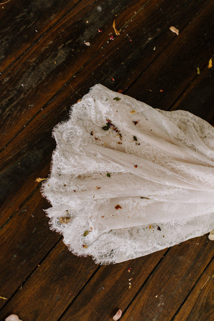 Eco-confetti on the tarin of the dress as the bride walks back down the aisle at The Wedding Social Co