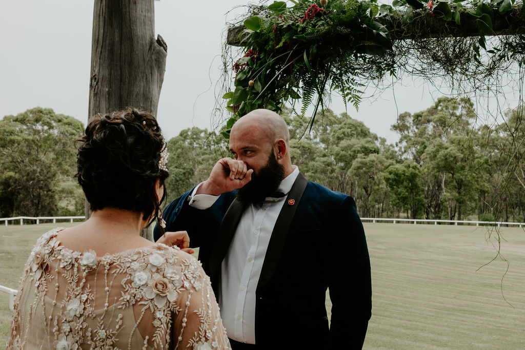 Groom crying after seeing his bride in a gown during their first look at Wandin Valley wedding