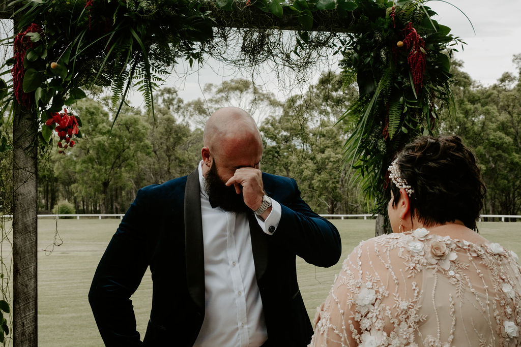 Groom crying after seeing his bride in a gown during their first look at Wandin Valley wedding