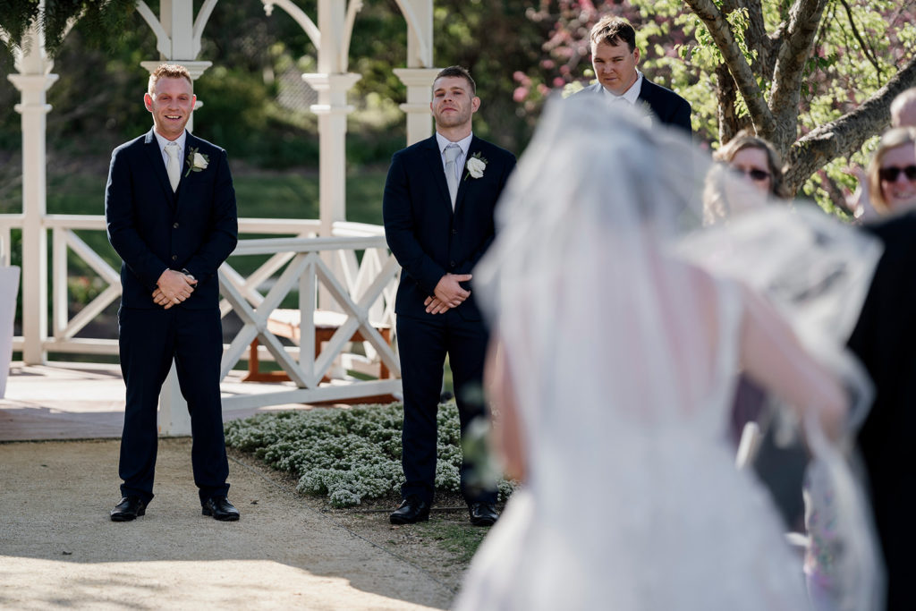 Hunter Valley Gardens wedding groom looking at bride walking down the aisle