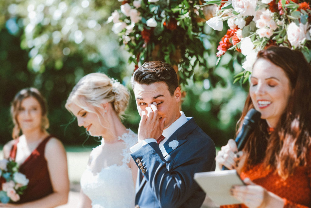 groom wiping a tear from his eye